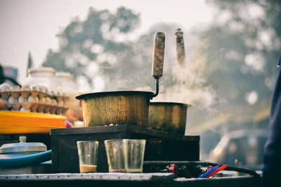 Close-up of steam emitting from utensils on stove