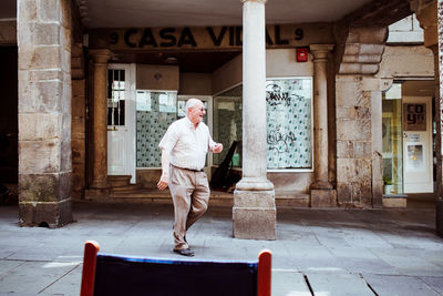 Full length of man standing in front of building