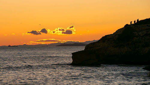 Scenic view of sea against orange sky