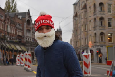 Portrait of man standing on street in city