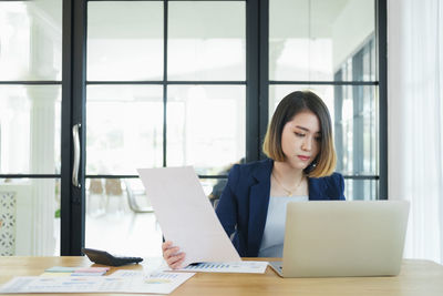 Woman working on table at home