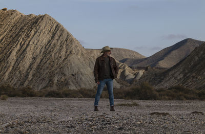 Adult man in cowboy hat in tabernas desert, almeria, spain