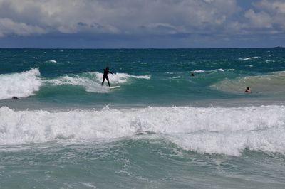 Surfers in the turquoise indian ocean waves at scarborough beach in western australia