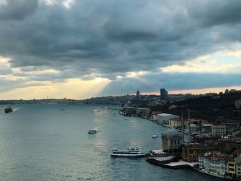 Scenic view of sea and buildings against sky at sunset