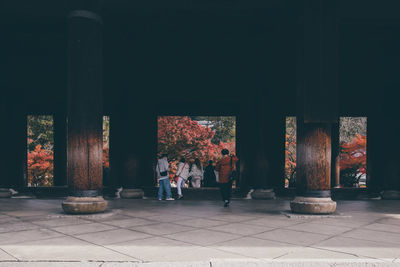 Rear view of people walking in temple