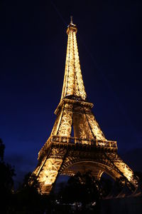 Low angle view of illuminated building against sky at night