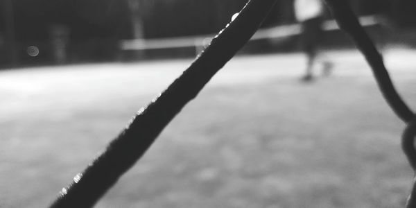 Close-up of silhouette chain on field by street
