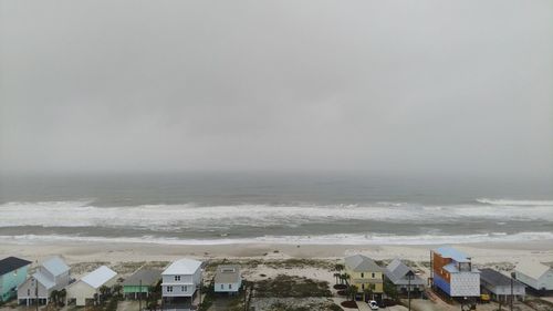 High angle view of beach by buildings against sky