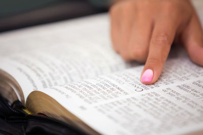 Close-up of hand on book