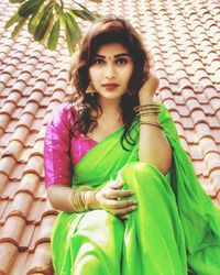 Portrait of young woman sitting outdoors