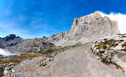 Rock formations on road against sky