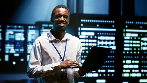 Portrait of young man using digital tablet in office