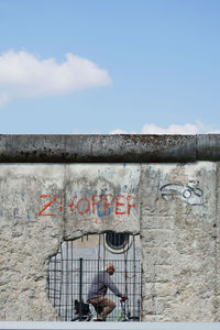 Graffiti on wall against sky