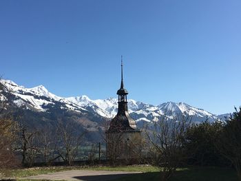 Scenic view of snowcapped mountains against clear blue sky