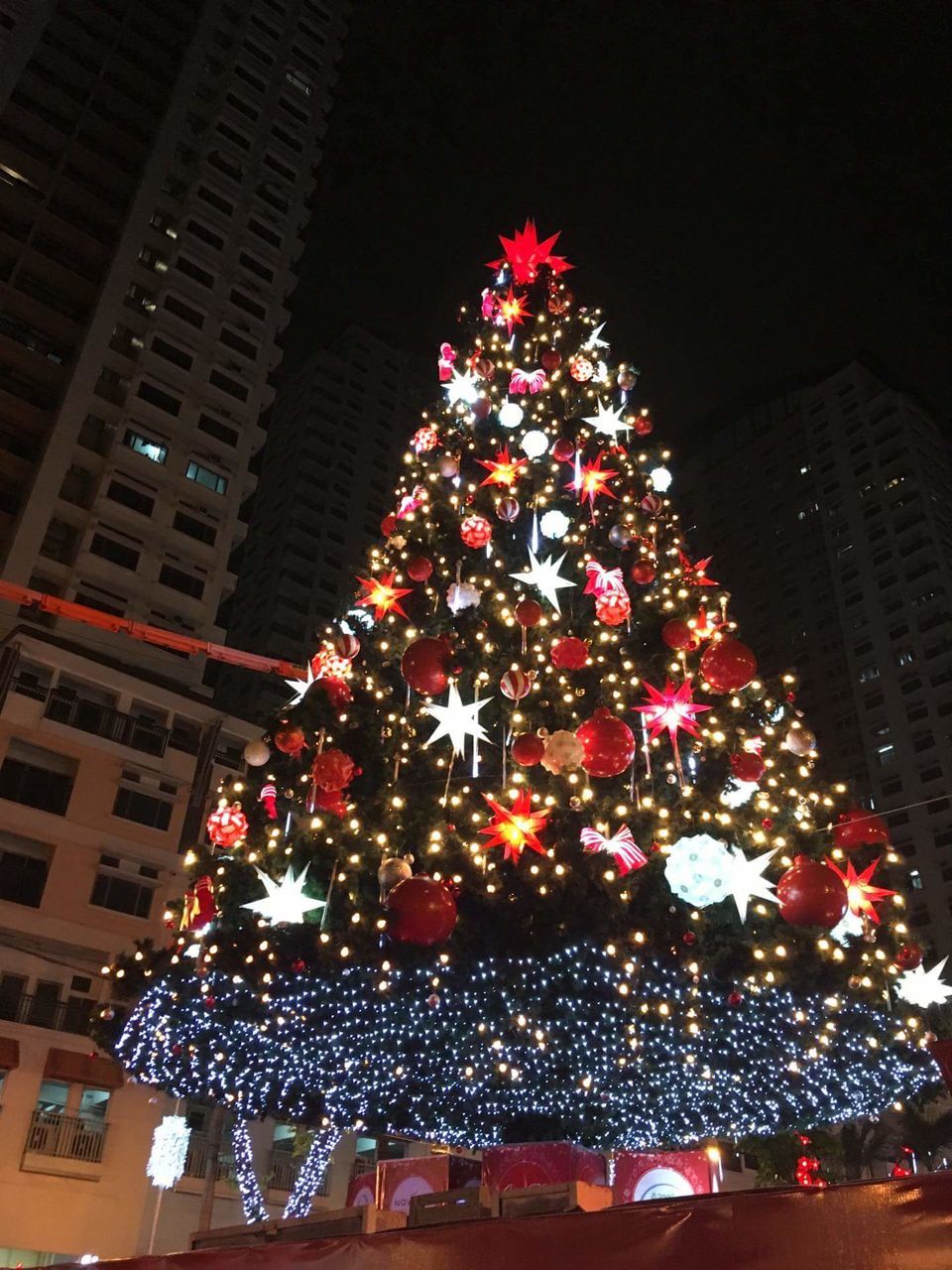 christmas, christmas tree, celebration, christmas decoration, illuminated, tradition, christmas lights, decoration, holiday - event, night, tree, tree topper, christmas ornament, cultures, celebration event, vacations, building exterior, architecture, low angle view, no people, indoors