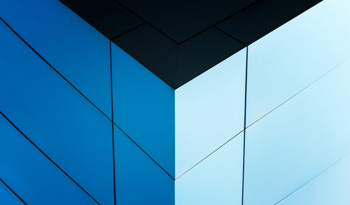 Low angle view of modern building against clear blue sky