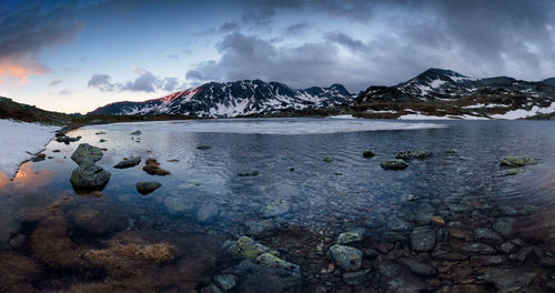 Scenic view of snowcapped mountains against sky in thr morning at bucura lake in retezat mountains 