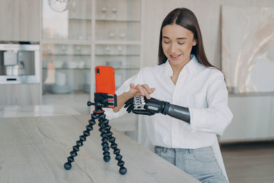 Young woman using mobile phone in laboratory