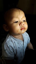 Cute girl with messy face against black background