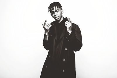 Portrait of young woman against white background