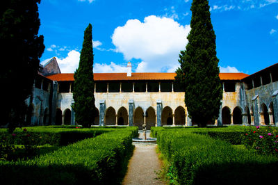 Panoramic view of garden and buildings against sky