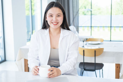Portrait of young businesswoman working on table