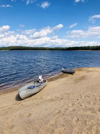 Boat moored on beach against sky