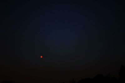 Low angle view of silhouette moon against sky at night