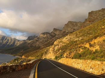 Road amidst mountains against sky