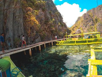 Scenic view of footbridge over mountain against sky