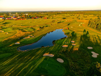 High angle view of green landscape against sky