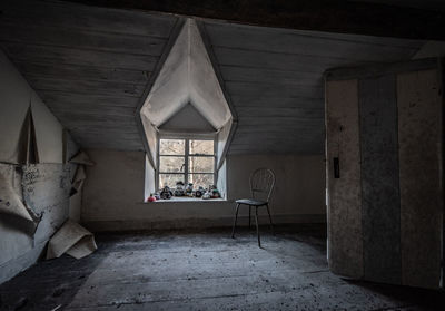 Empty chair in abandoned building