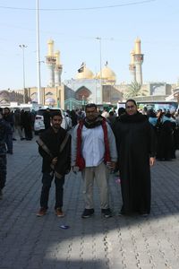 People standing in city against sky