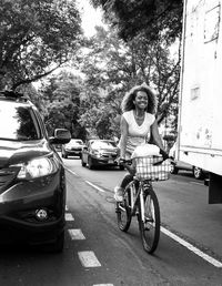 Young woman with bicycle standing in city