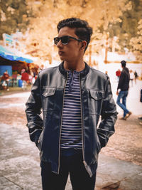 Young man wearing sunglasses standing outdoors