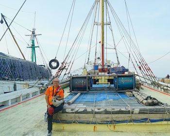 Sailboat at construction site against sky