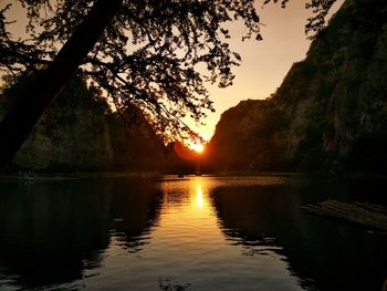 Scenic view of lake against sky during sunset