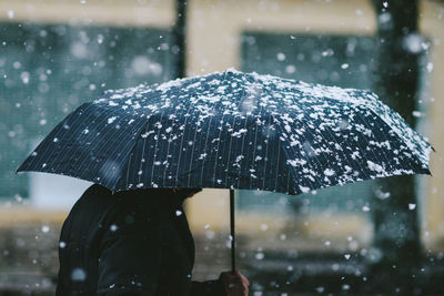 Snow falling on umbrella