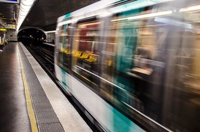 Blurred motion of train at railroad station