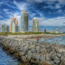 View of cityscape against cloudy sky