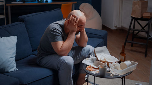 Depressed man sitting at home