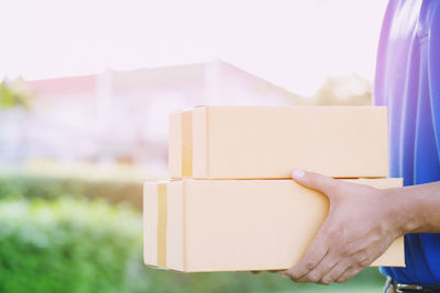 Close-up of hand holding paper stack