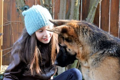 Young woman with cat sitting outdoors