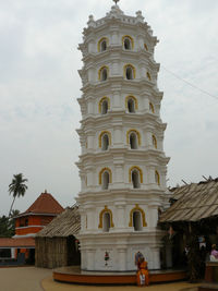 Low angle view of building against cloudy sky