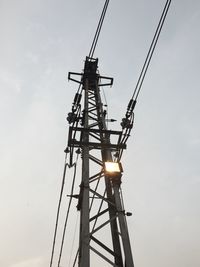 Low angle view of crane against sky