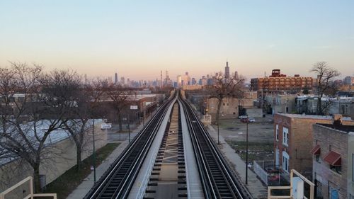 High angle view of railroad tracks in city against clear sky