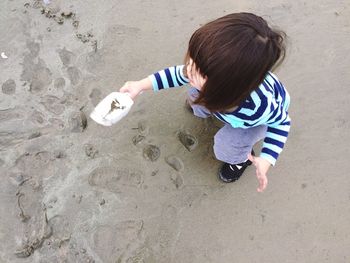 Full length of girl playing at beach