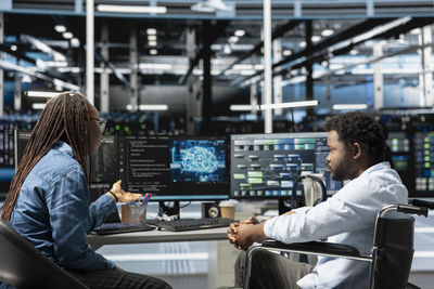 Rear view of woman working at supermarket