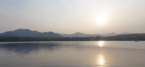 Scenic view of lake against sky during sunset