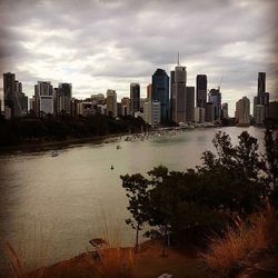 Cityscape against cloudy sky